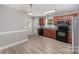 Kitchen featuring wood cabinets, modern appliances, and laminate flooring at 8309 Knapp Ct, Locust, NC 28097