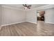 Bright and airy living room featuring wood-look flooring and ceiling fan at 8309 Knapp Ct, Locust, NC 28097