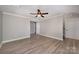 Spacious living room with modern flooring and a ceiling fan, perfect for relaxation at 8309 Knapp Ct, Locust, NC 28097