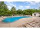 Community pool featuring plentiful lounge chairs and adjacent changing area at 8309 Knapp Ct, Locust, NC 28097
