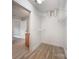 Bright walk-in closet with shelving units and wood flooring; bathroom and bedroom access at 8309 Knapp Ct, Locust, NC 28097