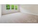 Bright bedroom featuring plush carpet, recessed lighting, and view of backyard at 10113 Mamillion Dr, Huntersville, NC 28078