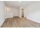 Well lit bonus room featuring hardwood floors with access to laundry room at 10113 Mamillion Dr, Huntersville, NC 28078