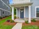Charming front porch with stone accents and a well-maintained lawn at 10113 Mamillion Dr, Huntersville, NC 28078