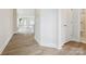 Hallway with durable floors leading to a bathroom and living space with natural light at 10113 Mamillion Dr, Huntersville, NC 28078