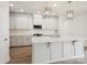 Modern kitchen featuring white cabinets, a center island with pendant lighting, and stainless steel appliances at 10113 Mamillion Dr, Huntersville, NC 28078