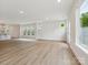 Bright and open living room with backyard access and view of modern kitchen at 10113 Mamillion Dr, Huntersville, NC 28078