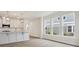 Bright, open floor plan with hardwood flooring, modern lighting, and views of neighborhood through large windows at 10113 Mamillion Dr, Huntersville, NC 28078