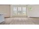Open living space with several windows for natural light and hardwood floors throughout at 10113 Mamillion Dr, Huntersville, NC 28078