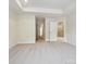 Spacious main bedroom featuring plush carpet and access to the ensuite bathroom at 10113 Mamillion Dr, Huntersville, NC 28078