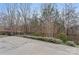 Concrete patio area surrounded by trees and a black metal fence at 11604 Bradford Park Dr, Davidson, NC 28036