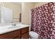 Bathroom featuring a white sink with dark wood cabinet and a shower with a floral shower curtain at 11604 Bradford Park Dr, Davidson, NC 28036