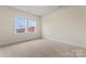 Well-lit bedroom with two windows and neutral carpet, offering natural light at 11604 Bradford Park Dr, Davidson, NC 28036
