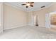 Spacious bedroom with neutral carpet, ceiling fan, and access to an en-suite bathroom at 11604 Bradford Park Dr, Davidson, NC 28036