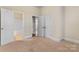Bedroom features neutral carpet, trim, doors, and easy access to a full bathroom at 11604 Bradford Park Dr, Davidson, NC 28036