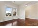 Bedroom with hardwood floors and large windows looking out on a well-manicured lawn at 11604 Bradford Park Dr, Davidson, NC 28036