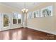 Sun-drenched dining room with hardwood floors, decorative lighting, and views of the backyard at 11604 Bradford Park Dr, Davidson, NC 28036