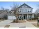 Charming two-story home with a two-car garage, inviting porch, and manicured landscaping at 11604 Bradford Park Dr, Davidson, NC 28036