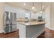 Modern kitchen features stainless steel appliances, granite countertops, and a large center island at 11604 Bradford Park Dr, Davidson, NC 28036