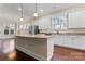 Bright kitchen featuring granite countertops, white cabinetry, stainless appliances, and a large island at 11604 Bradford Park Dr, Davidson, NC 28036