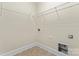 Bright laundry room with white wire shelving and utility connections, offering ample storage at 11604 Bradford Park Dr, Davidson, NC 28036