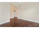 Living room with gleaming hardwood floors and view of entry hall and staircase at 11604 Bradford Park Dr, Davidson, NC 28036