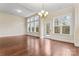 Bright living room with hardwood floors, chandelier lighting, and views of the backyard at 11604 Bradford Park Dr, Davidson, NC 28036