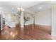 Spacious open-concept living area with hardwood floors, staircase, and ample natural light at 11604 Bradford Park Dr, Davidson, NC 28036