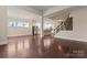 Open-concept living space with hardwood floors, staircase, and adjacent kitchen area at 11604 Bradford Park Dr, Davidson, NC 28036