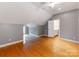 Spacious bedroom with hardwood floors and ensuite bathroom featuring a slanted ceiling at 123 Yellow Jacket Cir, Mooresville, NC 28117