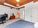 Spacious bedroom with accent ceiling and chandelier, large window, and carpeted floors at 123 Yellow Jacket Cir, Mooresville, NC 28117