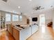 Expansive living room with hardwood floors, neutral walls, multiple windows, and fan-lights at 123 Yellow Jacket Cir, Mooresville, NC 28117