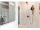 Elegant white marble bathroom shower with bronze fixtures, hand shower, and patterned tile floor at 123 Yellow Jacket Cir, Mooresville, NC 28117