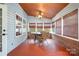 Relaxing sunroom with multiple windows, ceiling fan, and wicker furniture, perfect for enjoying the outdoors at 14414 Arbor Ridge Dr, Charlotte, NC 28273