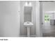 A well-lit half bath with a pedestal sink and a view into the living area of the home at 213 Lake George Dr, Shelby, NC 28152