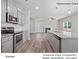 Stylish kitchen boasts stainless steel appliances, gray cabinets, and open layout at 213 Lake George Dr, Shelby, NC 28152