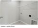 Upstairs laundry room with tile floor, wire rack and washer and dryer hook ups at 213 Lake George Dr, Shelby, NC 28152