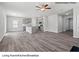 Open-concept living room with kitchen, dining area and fireplace, featuring hard wood floors and ceiling fan at 213 Lake George Dr, Shelby, NC 28152