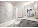 Elegant bathroom with a shower-tub combo featuring modern fixtures and finishes and a gray vanity at 2306 Elizabeth Mill Pl, Charlotte, NC 28208