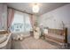 Lovely Bedroom featuring a gold crib, natural light, and tasteful décor with a light pink color theme at 2306 Elizabeth Mill Pl, Charlotte, NC 28208
