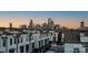 Modern townhomes showcase stunning city skyline views in the background at 2306 Elizabeth Mill Pl, Charlotte, NC 28208