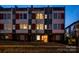 Modern townhome exterior at dusk with glowing lights and a welcoming wreath on the door at 2306 Elizabeth Mill Pl, Charlotte, NC 28208