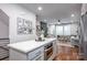 Modern kitchen with stainless steel appliances and eat in island that flows into the living room at 2306 Elizabeth Mill Pl, Charlotte, NC 28208