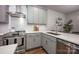 Modern kitchen features a stainless steel range hood, white subway tile backsplash, and lots of counter space at 2306 Elizabeth Mill Pl, Charlotte, NC 28208