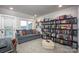 Comfortable living room with gray sofa, a white ottoman, and built in bookshelf at 2306 Elizabeth Mill Pl, Charlotte, NC 28208