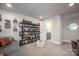 Inviting living room featuring a large bookcase, sofa, and a view to an adjacent bathroom at 2306 Elizabeth Mill Pl, Charlotte, NC 28208