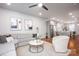 Bright living room with hardwood floors, a gray sofa, and access to the kitchen at 2306 Elizabeth Mill Pl, Charlotte, NC 28208