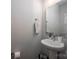 Clean powder room with a pedestal sink, a mirror, and a window for natural light at 2306 Elizabeth Mill Pl, Charlotte, NC 28208