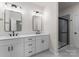 A bathroom features double sinks, sleek fixtures, and glass-enclosed shower at 2825 New Pineola Rd # 7A, Charlotte, NC 28208