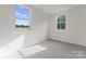 A carpeted bedroom with two windows at 2825 New Pineola Rd # 7A, Charlotte, NC 28208